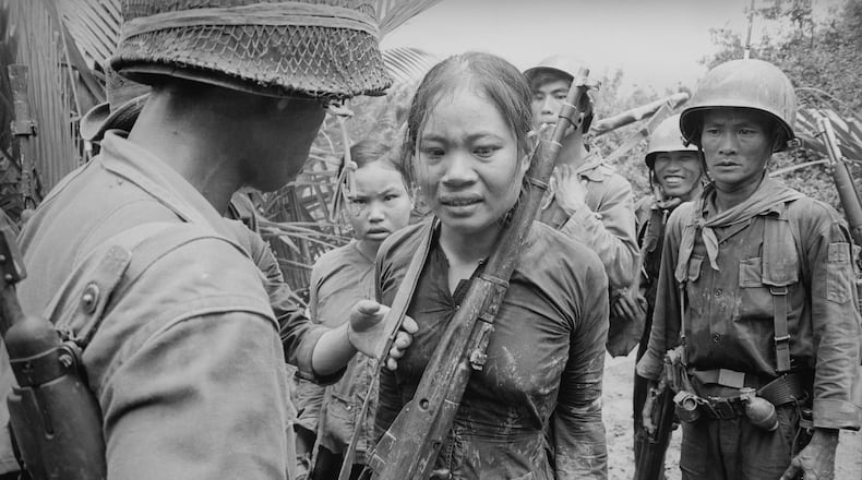 Suspected Viet Cong soldier carrying a Russian-made rifle, awaiting interrogation. August 25, 1965.