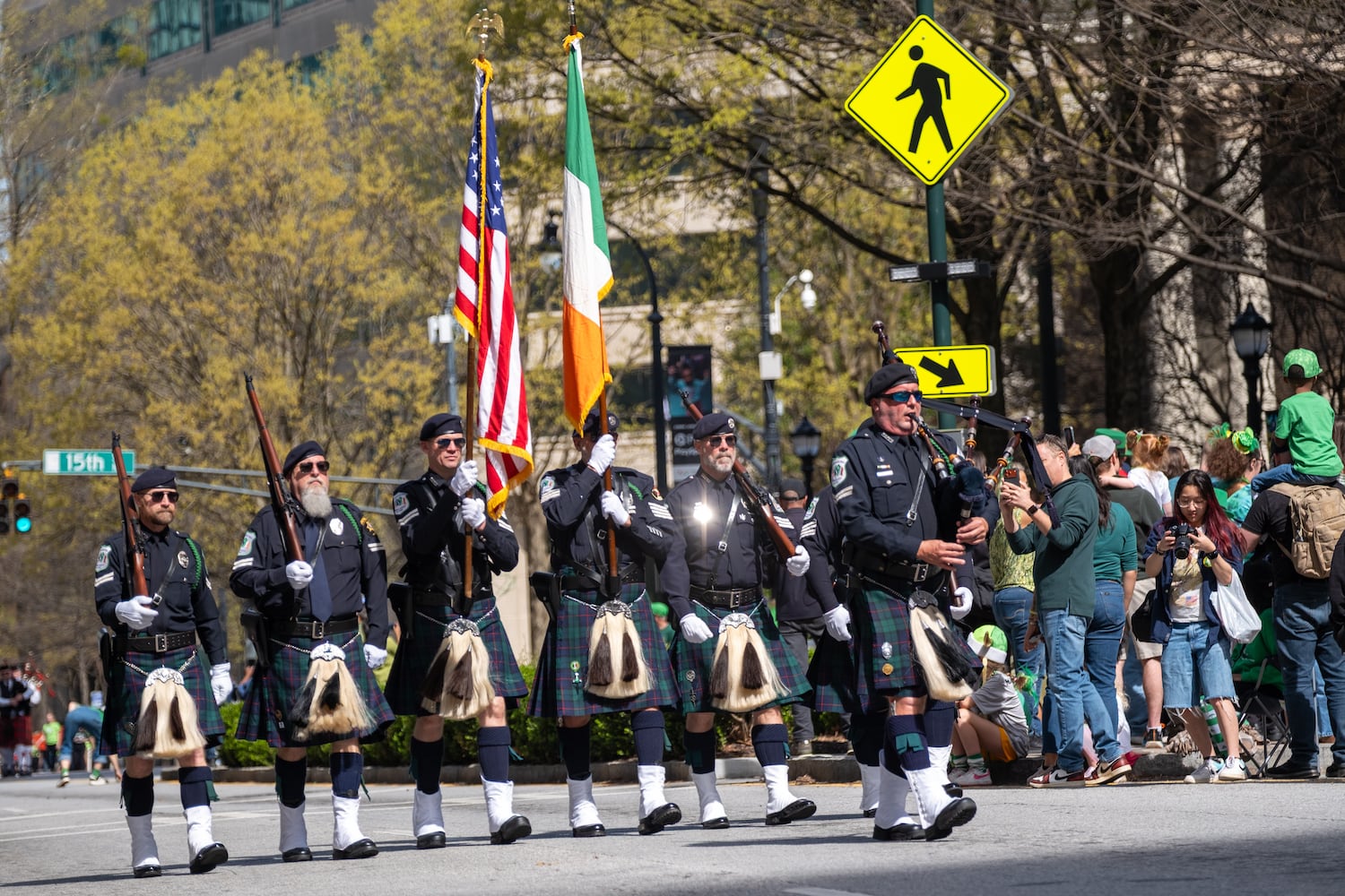 The Metropolitan Atlanta Police Emerald Society color guard makes its way down Peachtree Street during the Atlanta St. Patrick’s Parade on Saturday, March 14, 2026. (Ben Gray for the AJC)