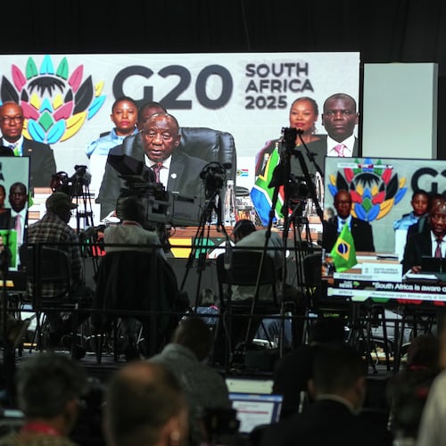 Members of the media watch on screens as South African President Cyril Ramaphosa addresses the opening session of the G20 leaders' summit, in Johannesburg, South Africa, Saturday, Nov. 22, 2025. (AP Photo/Jerome Delay)