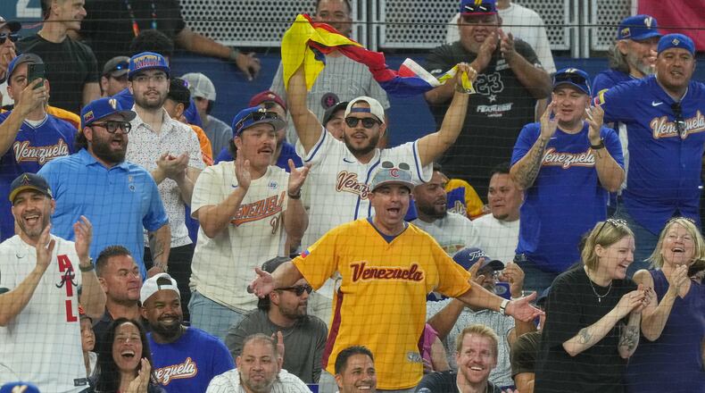 Venezuela fans cheer the team during a World Baseball Classic game against the Netherlands, Friday, March 6, 2026, in Miami. (AP Photo/Marta Lavandier)