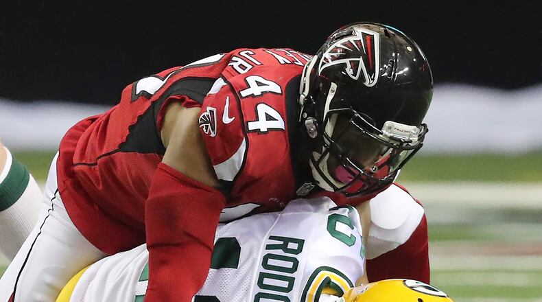 Vic Beasley Jr. (44) sacks Green Bay quarterback Aaron Rodgers when the Falcons and Packers met in October at the Georgia Dome. (Curtis Compton/AJC)