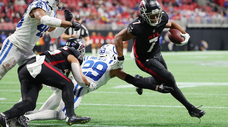 Atlanta Falcons running back Bijan Robinson (7) avoids a tackle from Indianapolis Colts defensive back JuJu Brents (29) during the fourth quarter at Mercedes-Benz Stadium on Sunday, Dec. 24, 2023, in Atlanta. (Kevin C. Cox/Getty Images/TNS)