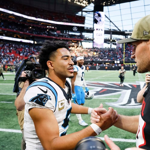 Atlanta Falcons quarterback Kirk Cousins (right) shakes hands with Carolina Panthers quarterback Bryce Young (left) after the Carolina Panthers defeated the Atlanta Falcons in overtime 30-27 at Mercedes-Benz Stadium in Atlanta on Sunday, Nov. 16, 2025. (Miguel Martinez/AJC)