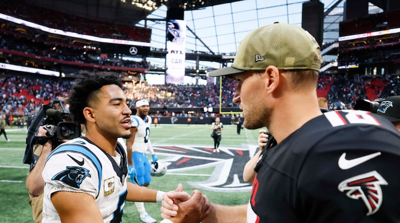 Atlanta Falcons quarterback Kirk Cousins (right) shakes hands with Carolina Panthers quarterback Bryce Young (left) after the Carolina Panthers defeated the Atlanta Falcons in overtime 30-27 at Mercedes-Benz Stadium in Atlanta on Sunday, Nov. 16, 2025. (Miguel Martinez/AJC)