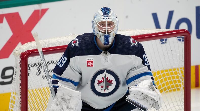 FILE - Winnipeg Jets goaltender Laurent Brossoit minds the net during an NHL hockey game against the Dallas Stars in Dallas, April 11, 2024. (AP Photo/Tony Gutierrez, File)