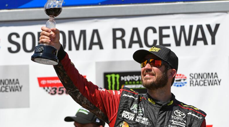 NASCAR driver Martin Truex Jr. raises the Champion's Goblet as he celebrates in the winner's circle after victory in the Toyota/Save Mart 350 at Sonoma Raceway in Sonoma, Calif., on June 24, 2018. (Jose Carlos Fajardo/Bay Area News Group/TNS)