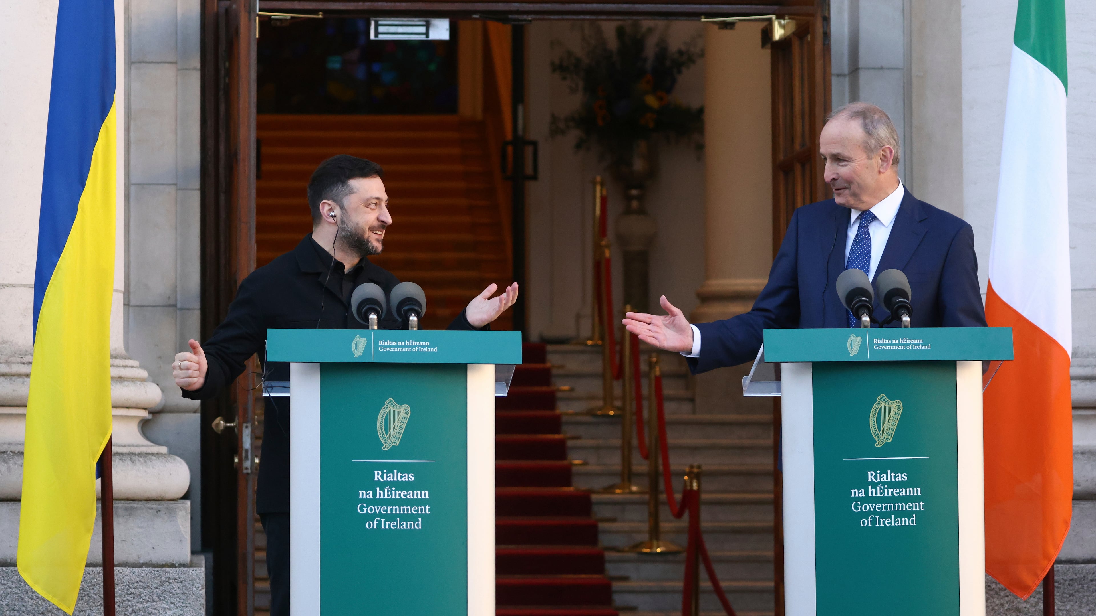 Ukraine's President Volodymyr Zelenskyy, left, and the Irish Prime Minister Micheal Martin gesture to each other as they take part in a joint press conference in Dublin, Ireland, Tuesday, Dec. 2, 2025. (AP Photo/Peter Morrison)