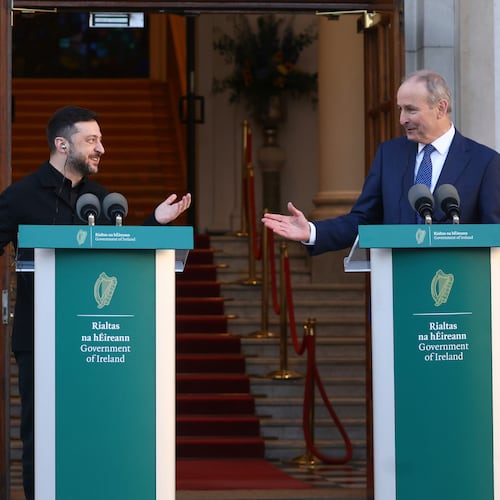Ukraine's President Volodymyr Zelenskyy, left, and the Irish Prime Minister Micheal Martin gesture to each other as they take part in a joint press conference in Dublin, Ireland, Tuesday, Dec. 2, 2025. (AP Photo/Peter Morrison)