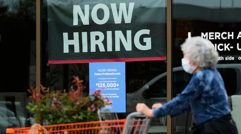 FILE - Hiring sign for sales professionals is displayed at a store, in Vernon Hills, Ill., Wednesday, April 15, 2026. (AP Photo/Nam Y. Huh, file)