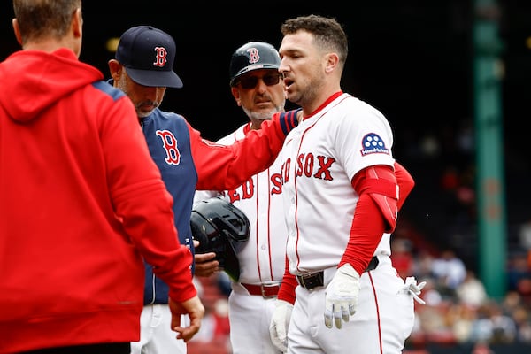 Boston Red Sox manager Alex Cora puts his hand on the shoulder of Alex Bregman as he leaves the game after injuring himself running out a single against the Baltimore Orioles during the fifth inning in the first baseball game of a doubleheader Friday, May 23, 2025, at Fenway Park in Boston. (AP Photo/Winslow Townson)