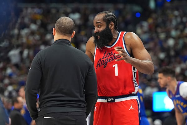 Los Angeles Clippers guard James Harden, right, confers with head coach Tyronn Lue, left, in the second half of Game 7 of an NBA basketball first-round playoff series against the Denver Nuggets, Saturday, May 3, 2025, in Denver. (AP Photo/David Zalubowski)