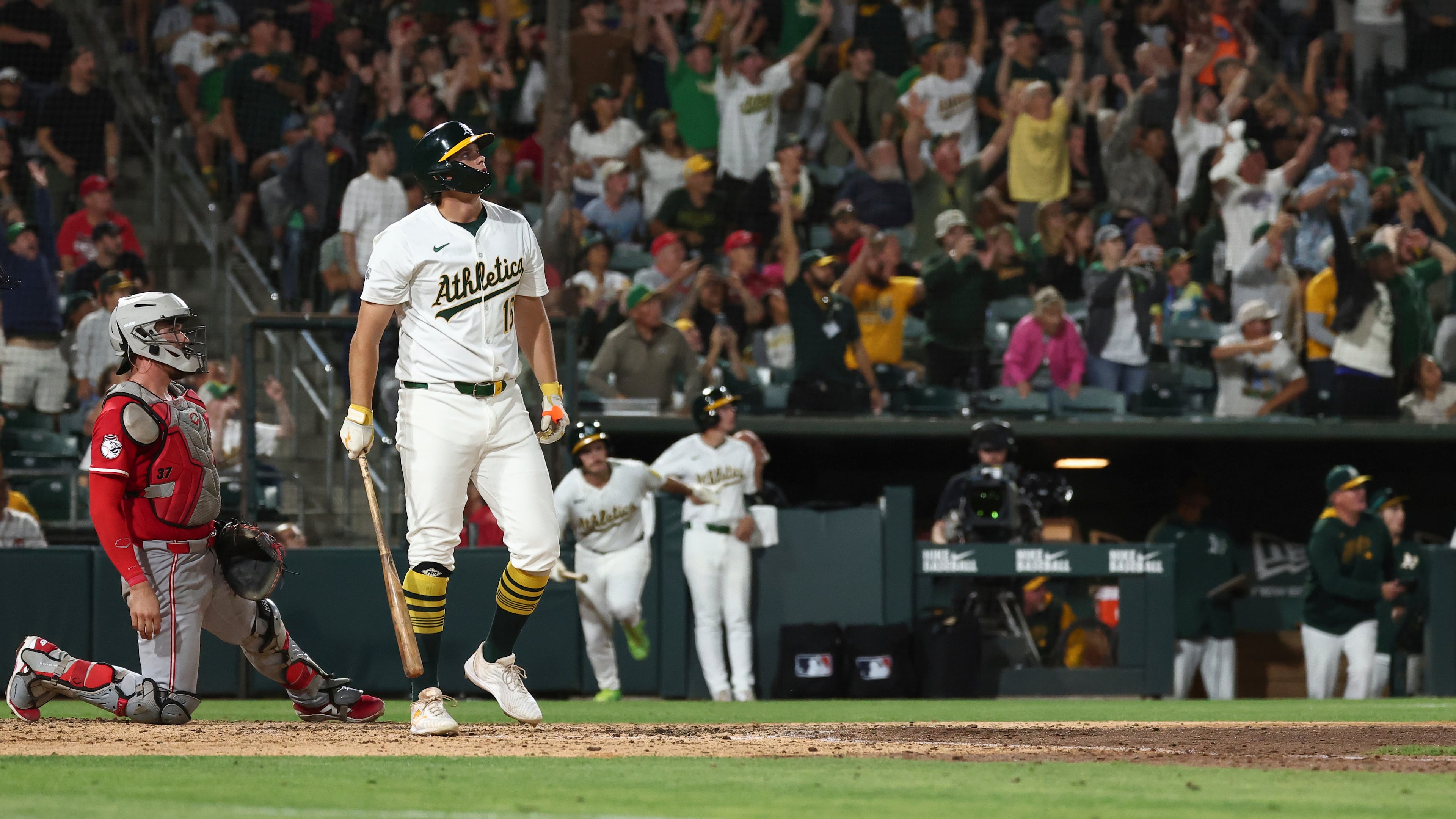 Athletics' Nick Kurtz, right, watches the ball after hitting a grand slam during the eighth inning of a baseball game against the Cincinnati Reds Saturday, Sept. 13, 2025, in West Sacramento, Calif. (AP Photo/Sara Nevis)