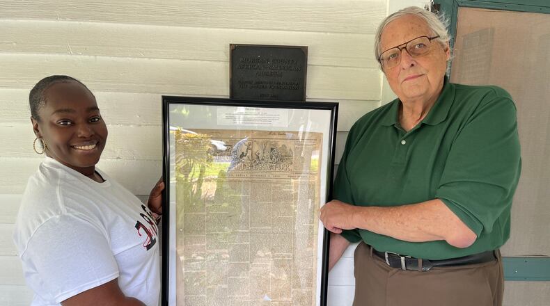 Frank Walsh, who owned and operated a rare book and document business for more than 35 years, donated an 1859 issue of the abolitionist paper 'The Liberator' to the Morgan County African American Museum on Juneteenth. Walsh is pictured with Museum Director Samantha Jones. (Photo Courtesy of Patrick Yost)