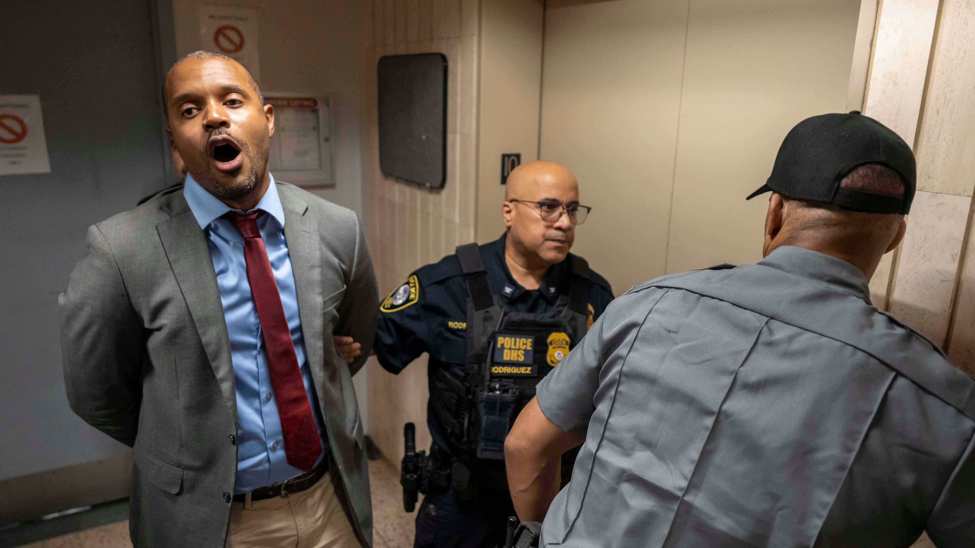 New York State Senator Jabari Brisport chants while detained by federal agents after demanding access to inspect the detainment facility at immigration court at the Jacob K. Javits federal building, Thursday, Sept. 18, 2025, in New York. (AP Photo/Yuki Iwamura)