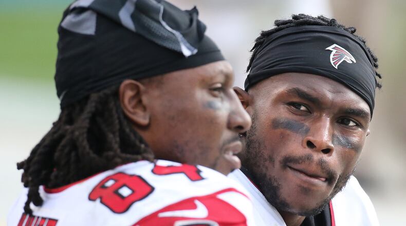 CHARLOTTE: Falcons wide receivers Roddy White and Julio Jones confer on the bench during a 38-0 loss to the Panthers in a football game on Sunday, Dec. 13, 2015, in Charlotte. Curtis Compton / ccompton@ajc.com