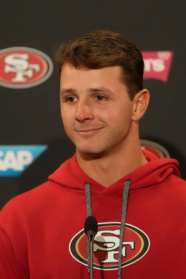 San Francisco 49ers quarterback Brock Purdy smiles during a news conference at the NFL football team's facility, Wednesday, May 21, 2025, in Santa Clara, Calif. (AP Photo/Jeff Chiu)