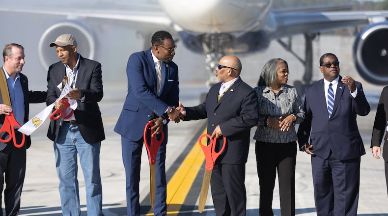Mayor Andre Dickens and Airport General Manager Balram “B” Bheodari shake hands after a ribbon cutting for a new Taxiway Improvement at Hartsfield-Jackson Atlanta International Airport Tuesday, Nov. 1, 2022. (Steve Schaefer/steve.schaefer@ajc.com)