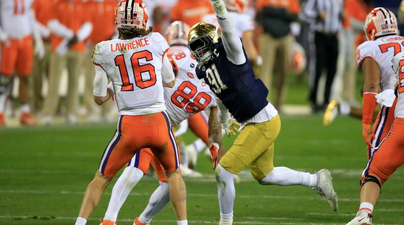 Notre Dame defensive lineman Adetokunbo Ogundeji (91) pressures Clemson quarterback Trevor Lawrence (16) during the second half of the ACC Championship game, Saturday, Dec. 19, 2020, in Charlotte, N.C. (AP Photo/Brian Blanco)