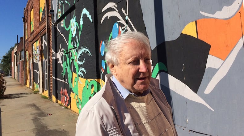 Former city planner Leon Eplan walks past the long-closed businesses on Georgia Avenue near the Braves park. Photo by Bill Torpy