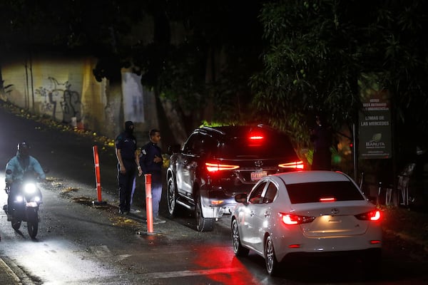 Police man a roadblock on a street leading to Argentina's embassy in Caracas, Venezuela, Tuesday, May 6, 2025, after members of Venezuela's political opposition left the diplomatic mission, where they had sheltered for more than a year to avoid arrest. (AP Photo/Cristian Hernandez)