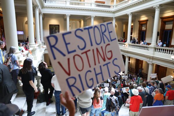 Activists protest at the state Capitol before lawmakers convene for a special session in June. (Arvin Temkar/AJC)