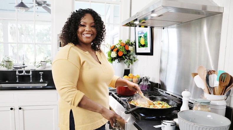 Kardea Brown, who spent her formative years in Atlanta and Charleston, S.C., pays homage to her Gullah-Geechee roots on her Food Network series, "Delicious Miss Brown," and now in her first cookbook, "The Way Home: A Celebration of Sea Islands Food and Family With Over 100 Recipes" (Amistad, $34.99). (Courtesy of Sully Sullivan)