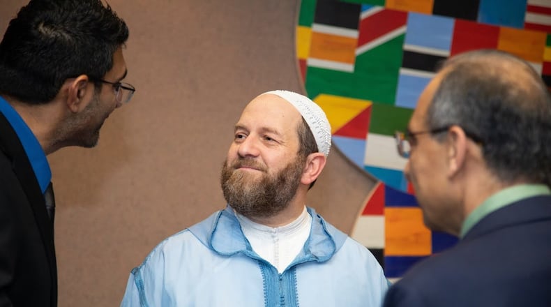 Sheikh Muhammad al-Ninowy talks with guests attending the launch of his “The Book of Love” held Sunday at The Carter Center. SARA ABUGIDEIRI / WESTERLY PHOTOGRAPHY