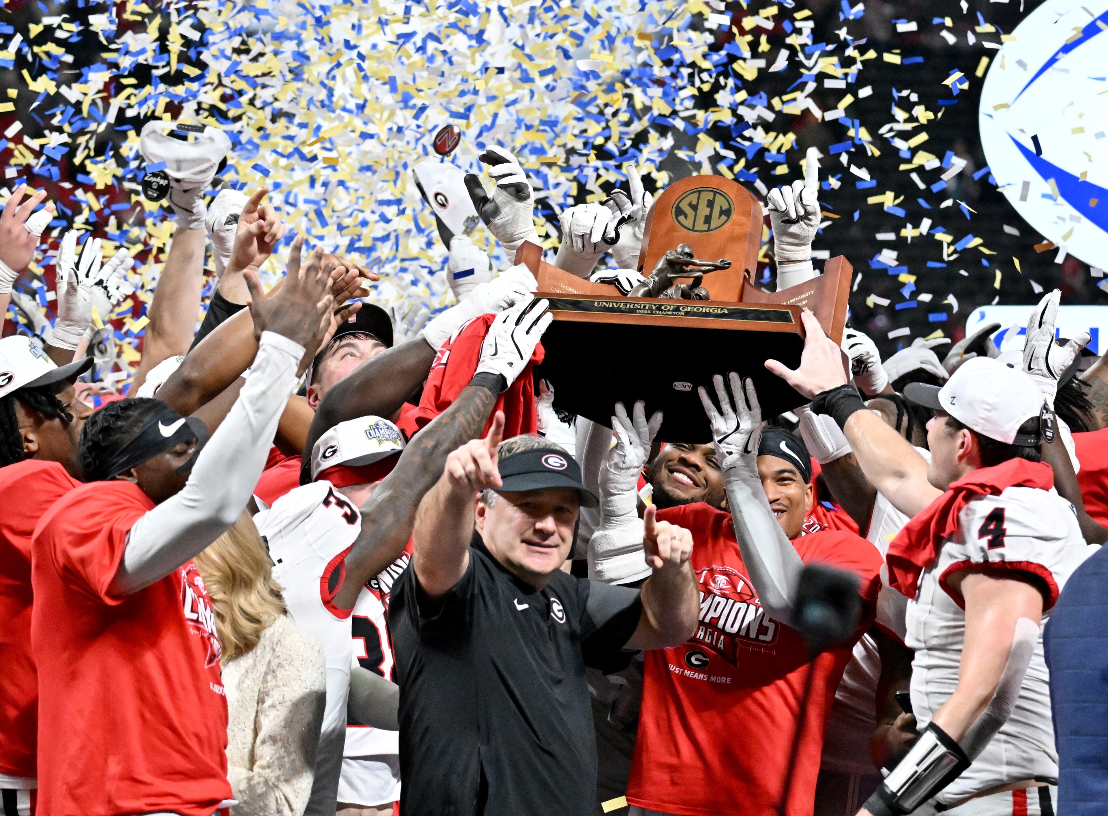 Georgia head coach Kirby Smart and players celebrate after defeating Alabama 28-7 in the SEC Championship football game at the Mercedes-Benz Stadium, Saturday, December 6, 2025 in Atlanta. (Hyosub Shin / AJC)