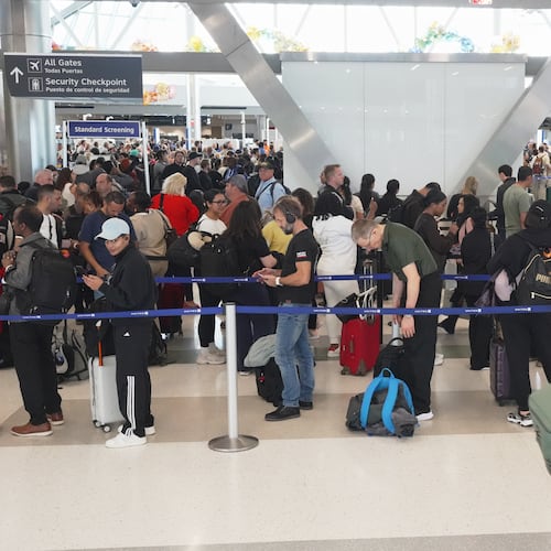 Airline passengers wait in long lines to get through the TSA security screening at George Bush Intercontinental Airport in Houston on Wednesday, March 18, 2026. (AP Photo/Lekan Oyekanmi)