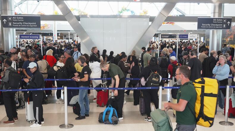 Airline passengers wait in long lines to get through the TSA security screening at George Bush Intercontinental Airport in Houston on Wednesday, March 18, 2026. (AP Photo/Lekan Oyekanmi)