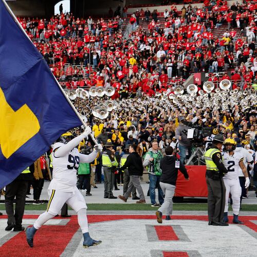 FILE - Michigan defensive lineman Cam Goode waves a Michigan flag after their win over Ohio State in an NCAA college football game ,Nov. 26, 2022, in Columbus, Ohio. (AP Photo/Jay LaPrete, File)