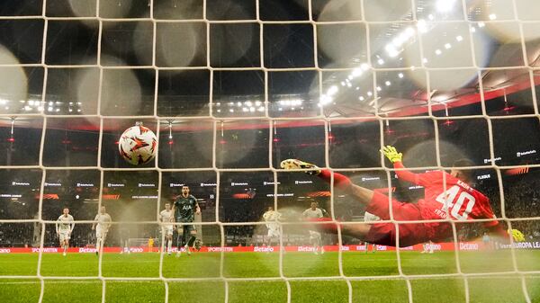 Tottenham's Dominic Solanke scores the opening goal from the penalty spot against Frankfurt's goalkeeper Kaua Santos during the Europa League quarterfinal second leg soccer match between Eintracht Frankfurt and Tottenham Hotspur, in Frankfurt, Germany, Thursday, April 17, 2025. (AP Photo/Martin Meissner)