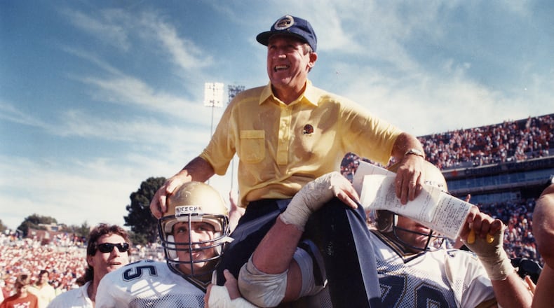 Yellow Jackets' coach Bobby Ross is carried off the field after a big victory in 1990. AJC file photo