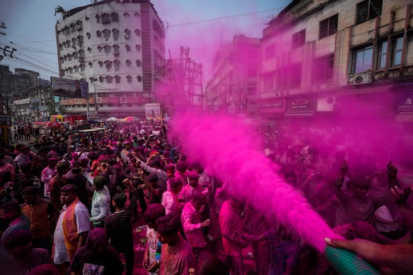 Indians dance as they celebrate Holi in Guwahati, India, Friday, March 14, 2025. (AP Photo/Anupam Nath)