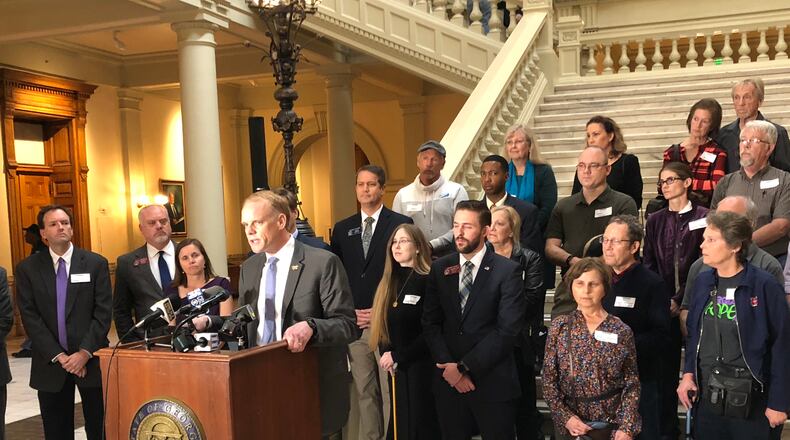 Republican candidate Clay Tippins speaks as a crowd of medical marijuana advocates, including state Sen. Michael Williams, listens. AJC/Greg Bluestein