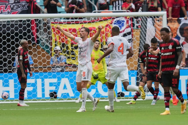 Bayern Munich's Leon Goretzka, left, celebrates after scoring his side's third goal during the Club World Cup round of 16 soccer match between CR Flamengo and Bayern Munich in Miami Gardens, Fla., Sunday, June 29, 2025. (AP Photo/Lynne Sladky)