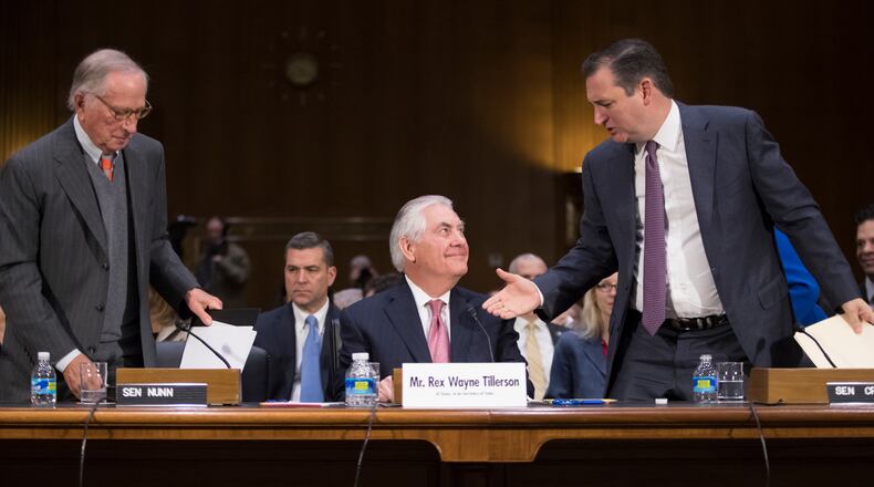 Secretary of State-designate Rex Tillerson, center, is flanked by former Georgia Sen. Sam Nunn and Sen. Ted Cruz, R-Texas, right, who introduced him on Capitol Hill in Washington, Wednesday, Jan. 11, 2107, at his confirmation hearing before the Senate Foreign Relations Committee. (AP Photo/J. Scott Applewhite)