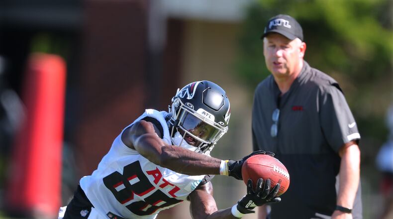 Falcons receiver Frank Darby makes a two-handed catch with wide receivers coach Dave Brock looking on during training camp last season in Flowery Branch. (Curtis Compton / Curtis.Compton@ajc.com)