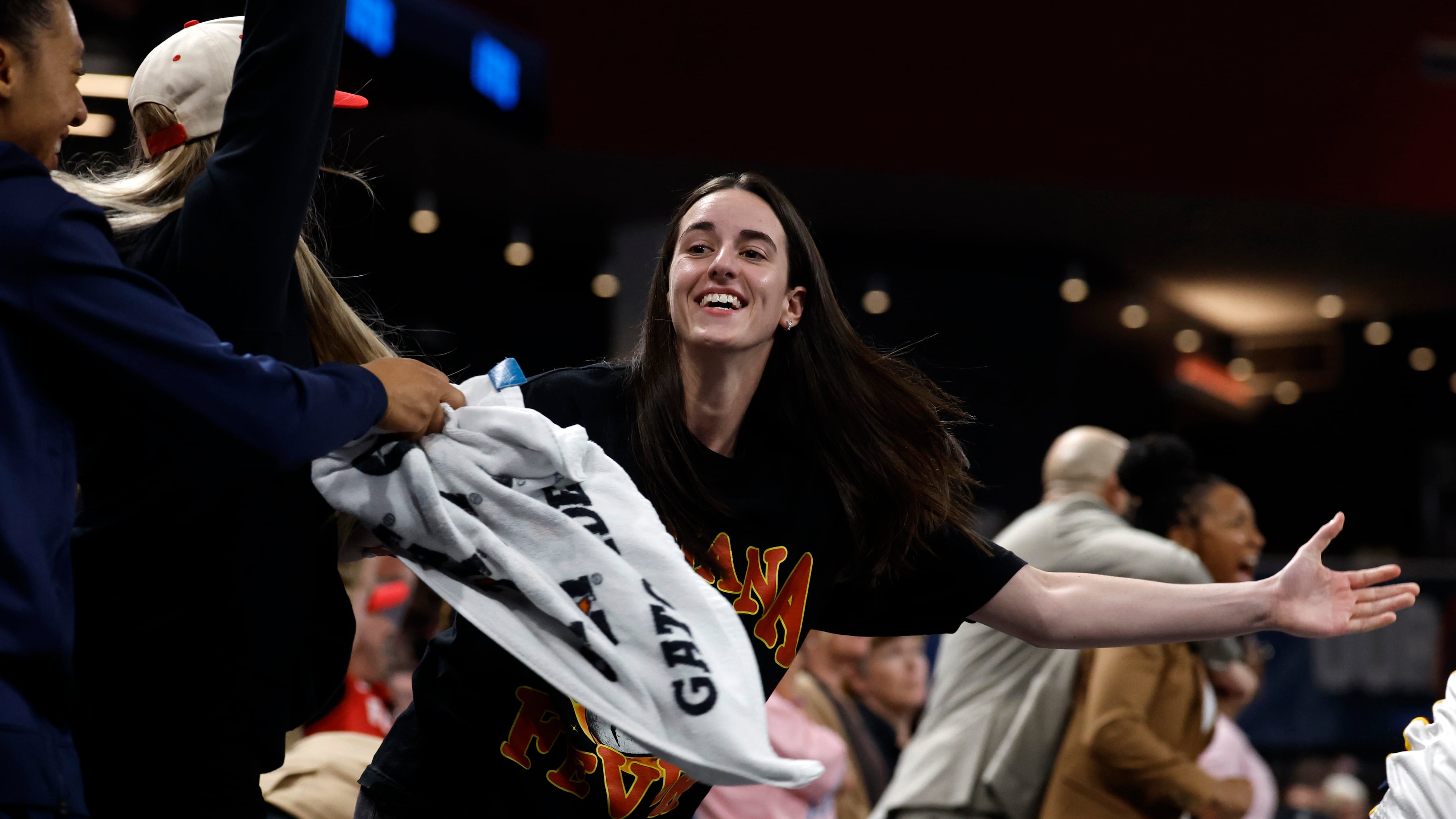 Indiana Fever guard Caitlin Clark, center, reacts after a score to take the lead over the Atlanta Dream during the second half of Game 3 in the first round of the WNBA basketball playoffs, Thursday, Sept. 18, 2025, in Atlanta. (AP Photo/Butch Dill)