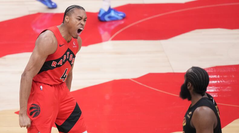Toronto Raptors forward Scottie Barnes (4) reacts after making a basket as Cleveland Cavaliers guard James Harden (1) looks on during the first half of Game 4 in a first-round NBA basketball playoffs series in Toronto, Sunday, April 26, 2026. (Nathan Denette/The Canadian Press via AP)