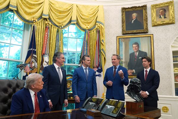 President Donald Trump, Interior Secretary Doug Burgum, Defense Secretary Pete Hegseth and Scott Nolan, CEO of General Matter, right, listen as Jacob DeWitte, CEO of Oklo Inc., speaks before Trump signed executive orders regarding nuclear energy in the Oval Office of the White House, Friday, May 23, 2025, in Washington. (AP Photo/Evan Vucci)