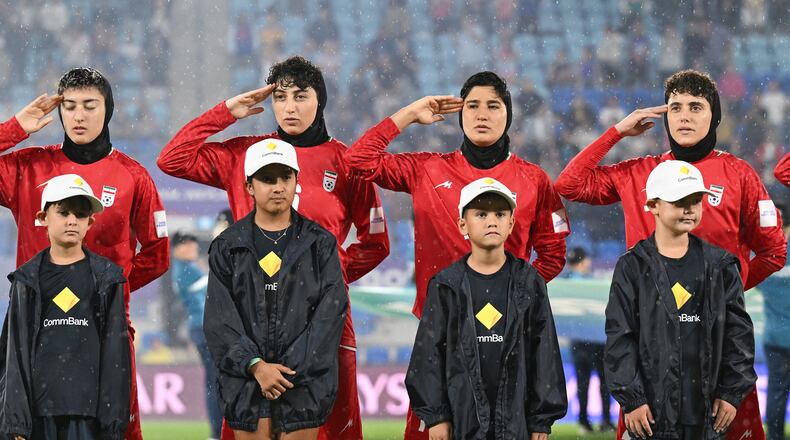 Iran players salute during their national anthem ahead of the Women's Asian Cup soccer match between Iran and the Philippines in Robina, Australia, Sunday, March 8, 2026. (Dave Hunt/AAP Image via AP)