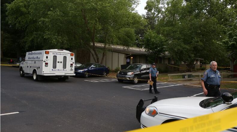 Gwinnett County police investigate a fatal shooting at the Hartford Run apartments in Buford on Friday, May 15, 2015. (Akili-Casundria Ramsess/Special to the AJC)