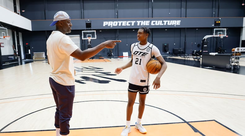 Damien Wilkins, (right) general manager and head of basketball operations at Overtime Elite Arena, interacts with his son Jayden Wilkins after he finishes practice on Monday, Nov. 6, 2023. (Miguel Martinez /miguel.martinezjimenez@ajc.com)