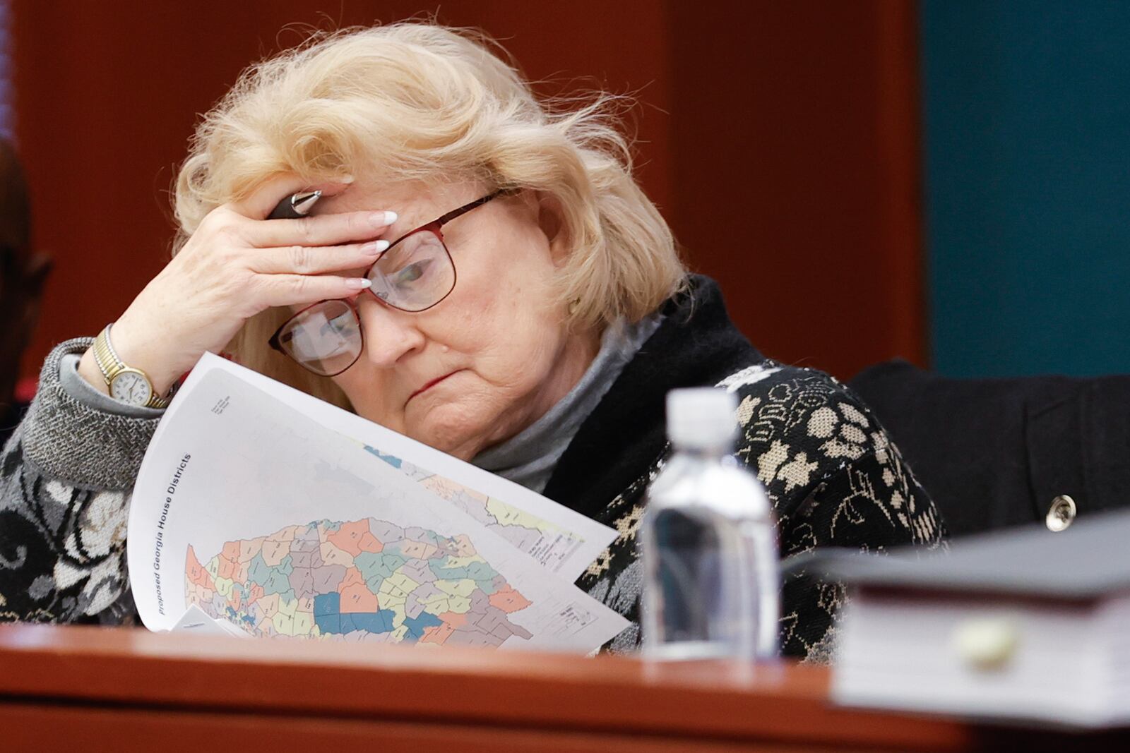 Rep. Darlene Taylor, R-Thomasville, flips through a packet with revised House district maps during a reapportionment and redistricting hearing at the Georgia State Capitol on Wednesday, Nov 29, 2023. (Natrice Miller/natrice.miller@ajc.com)