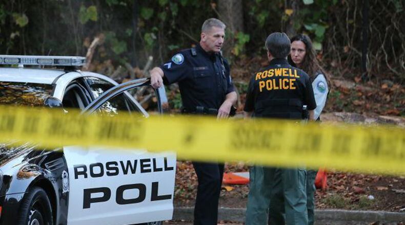 Roswell police officers talk near a crime scene.