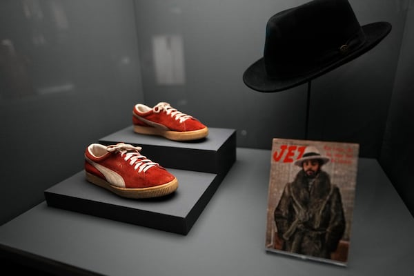 PUMA sneakers and a hat worn by Walt Frazier are displayed at the Metropolitan Museum of Art's Costume Institute exhibition, "Superfine: Tailoring Black Style," on Saturday, May 3, 2025, in New York. (Photo by Charles Sykes/Invision/AP)
