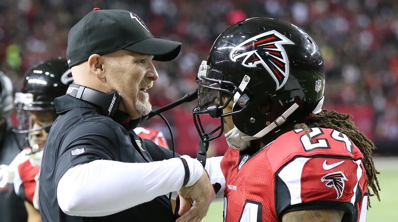 January 1, 2017, Atlanta: Falcons head coach Dan Quinn celebrates with running back Devonta Freeman after his 75-yard touchdown run against the Saints in an NFL football game on Sunday, Jan. 1, 2017, in Atlanta. Curtis Compton/ccompton@ajc.com