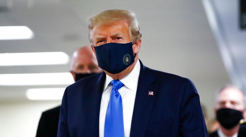 President Donald Trump wears a mask as he walks down the hallway during his visit to Walter Reed National Military Medical Center in Bethesda, Md., Saturday, July 11, 2020. (AP Photo/Patrick Semansky)