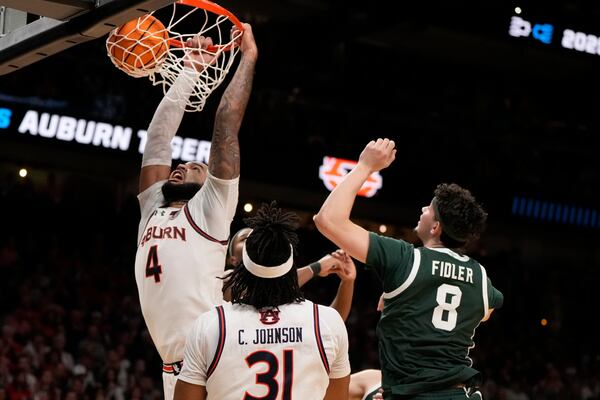Auburn forward Johni Broome (4) dunks against Michigan State during the second half in the Elite Eight of the NCAA college basketball tournament, Sunday, March 30, 2025, in Atlanta. (AP Photo/Brynn Anderson)